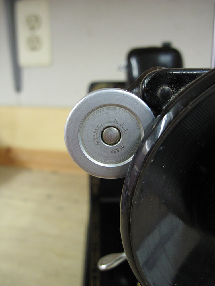 A closeup of the bobbin winder wheel, which reads "Simanco U.S.A. 45859"